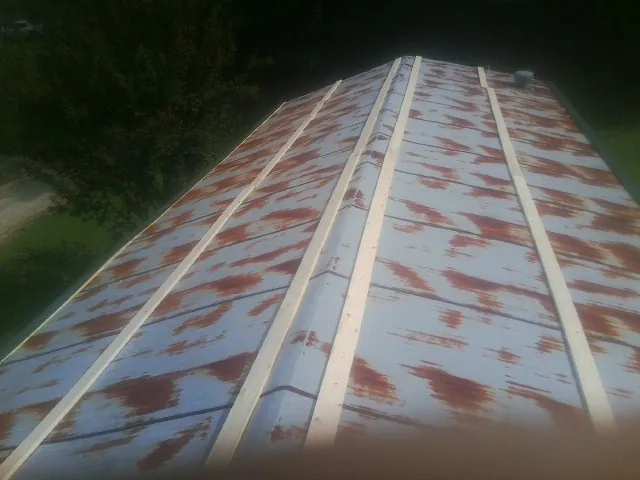 Rusted metal roof panels with new wood purlins before replacement — Storm Damage Roof Repair in Ridge Spring by Roofing Brothers