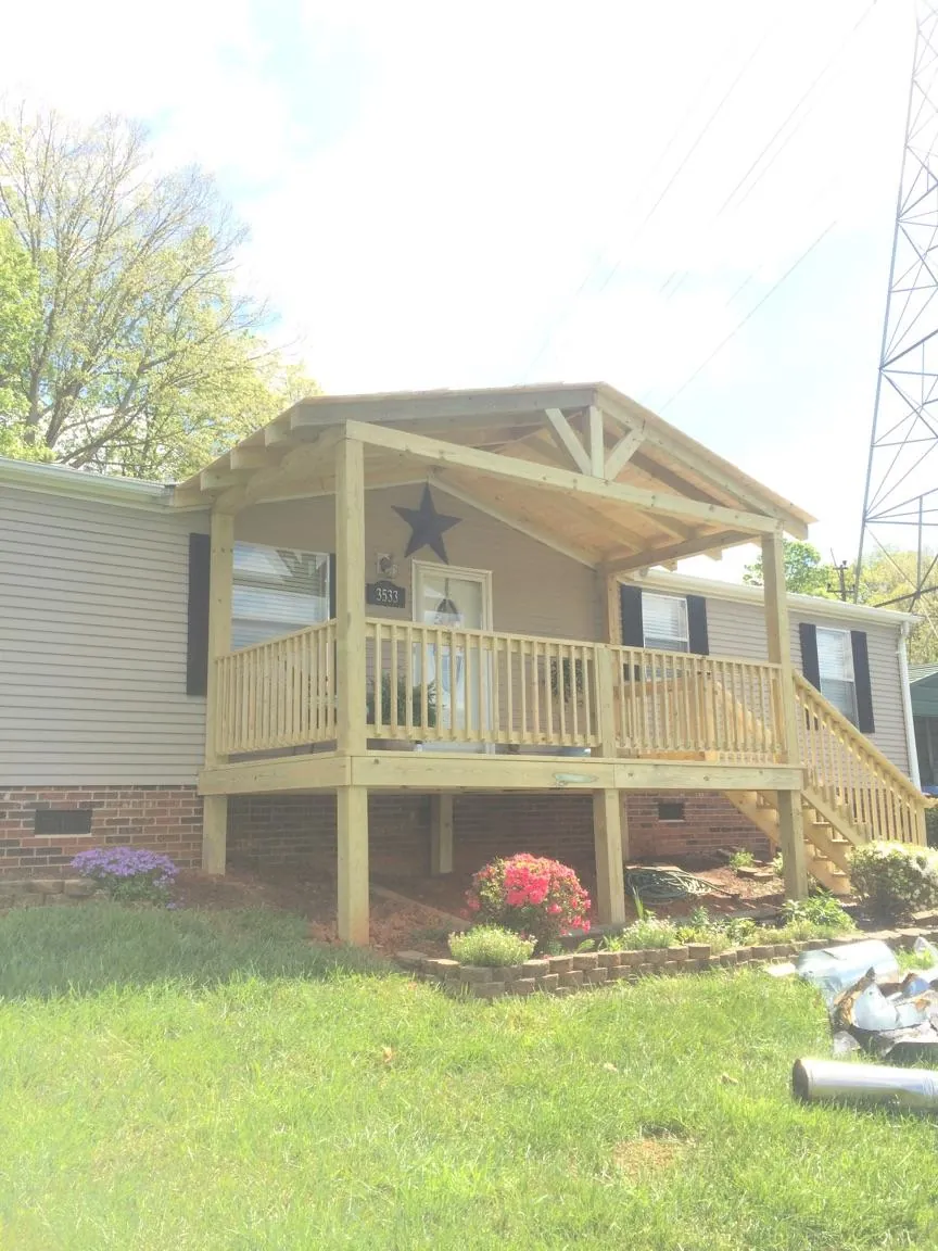 New gabled porch roof and deck railing added to a ranch home in Ridge Spring